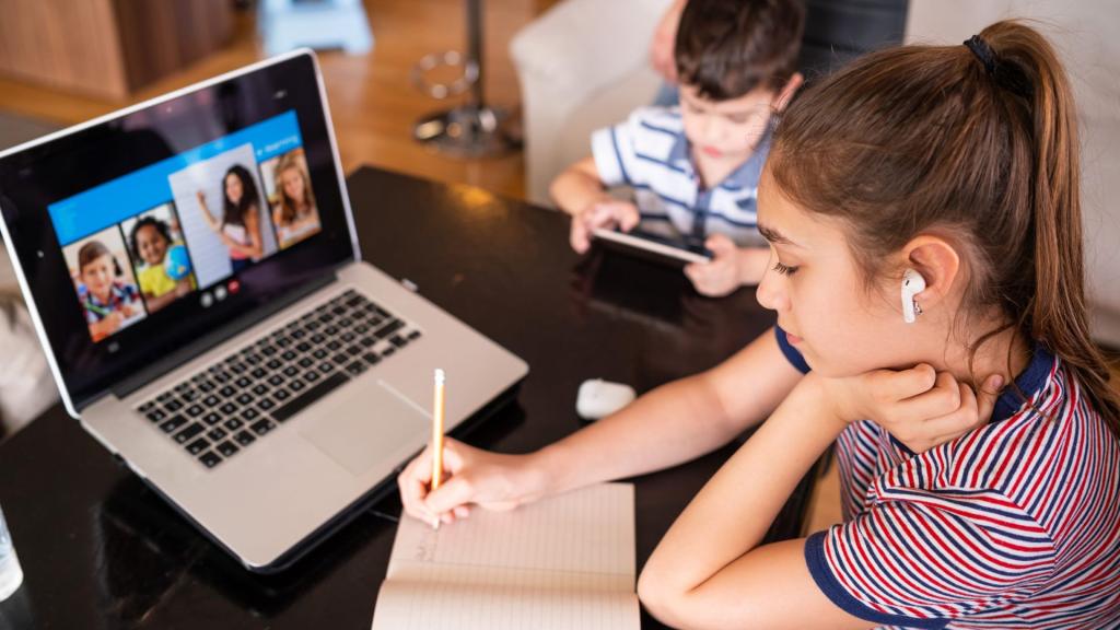 two children learning online in front of a computer