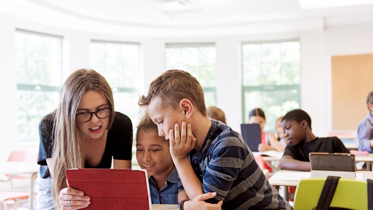 School kids in class using a digital tablet